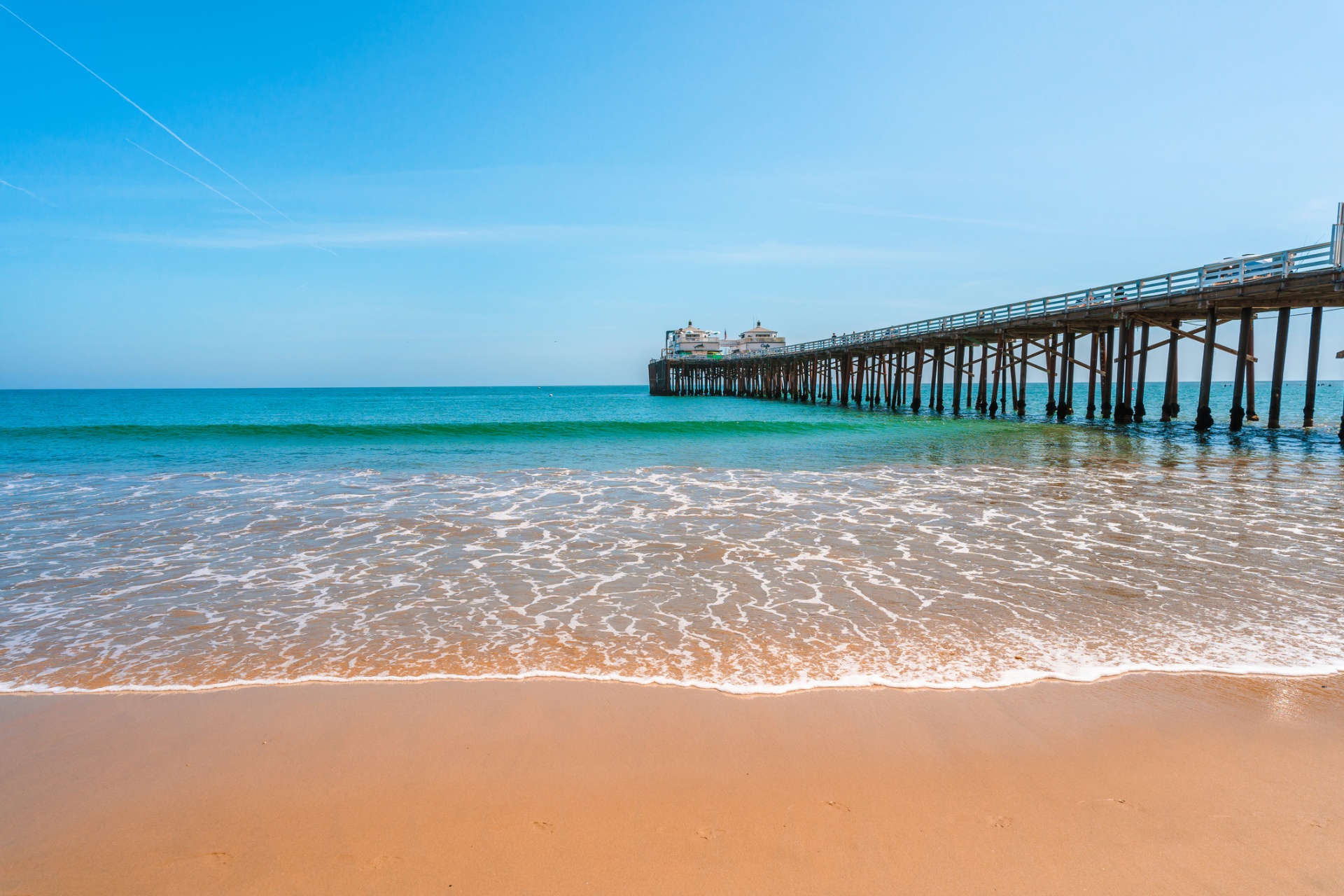 Malibu Pier stretching over turquoise water on a sunny day